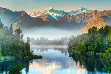 Early morning fog and mist at Lake Matheson but with enough light to capture the reflections of the Southern Alps clipart