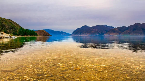 Wide range of colour in the late afternoon by the beach at Lake Hawea