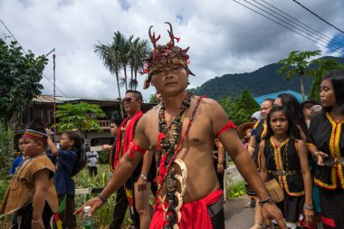 SARAWAK, MALAYSIA: JUNE 1, 2014: People of the Bidayuh tribe, an indigenous native people of Borneo, in traditional costumes, take part in a street parade to celebrate the Gawai Dayak festival. clipart