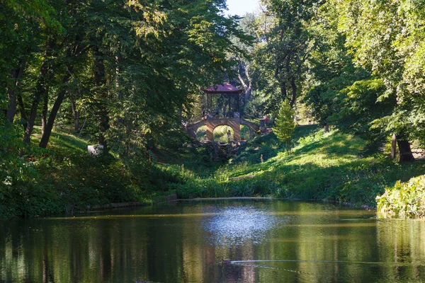 夏の日にArbooltum Oleksandriyaの湖にかかる中国の橋 Oleksandriya景観公園は東ヨーロッパ最大の公園の一つです ツェルクヴァ市 ウクライナだ 有名な観光地 — ストック写真