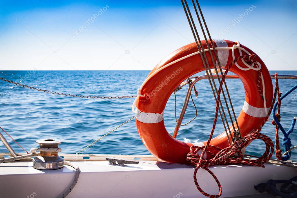 A lifebuoy on board the yacht. Blue sea, summer.
