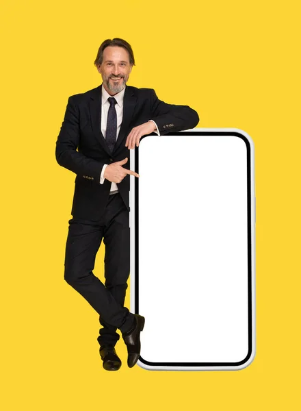 Handsome Businessman Black Suit Leaned Big Smartphone Pointing White Screen — Foto Stock