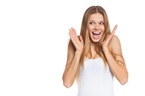 Surprised happy young woman looking sideways in excitement. Isolated over white background — Stock Photo, Image