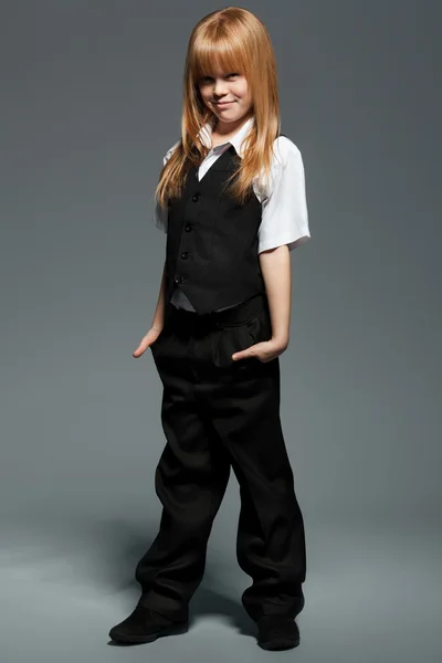 Full length little cute girl in white shirt, in black vest, in black trousers, isolated over grey background — Stock Photo, Image