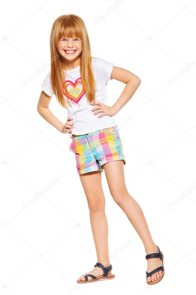 Full length a cheerful little girl with red hair in shorts and a shirt. isolated on the white background