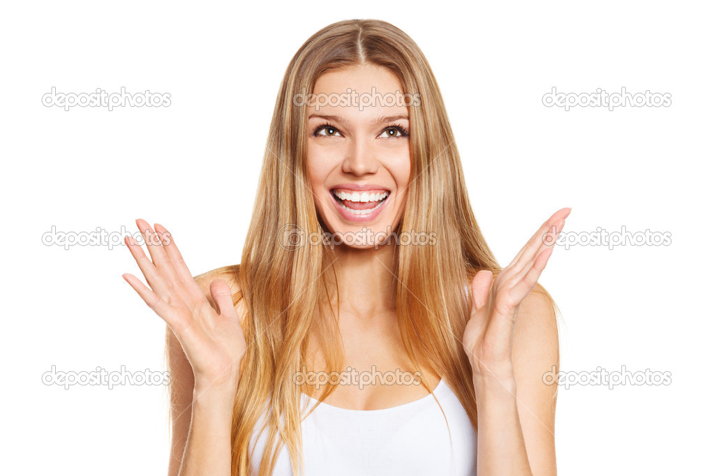 Surprised happy beautiful young woman looking up in excitement. Isolated over white background