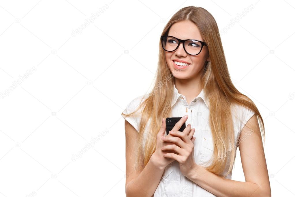Happy smiling woman holding a mobile phone looking away isolated on white background