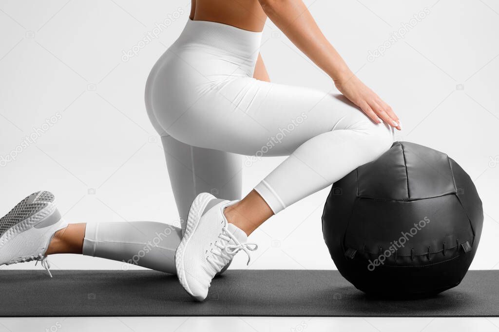 Sporty woman with med ball working out