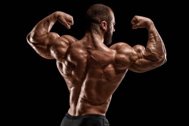 Muscular man showing back muscles, isolated on black background. Strong male rear view clipart