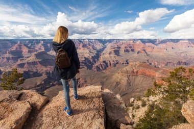 Travel in Grand Canyon, woman hiker with backpack enjoying view, USA