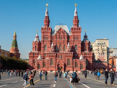 Moskova, Rusya - 5 Ekim 2021 Kızıl Meydan. Güneşli bir günde tarihi müze binası. Turistler meydanda yürüyor.