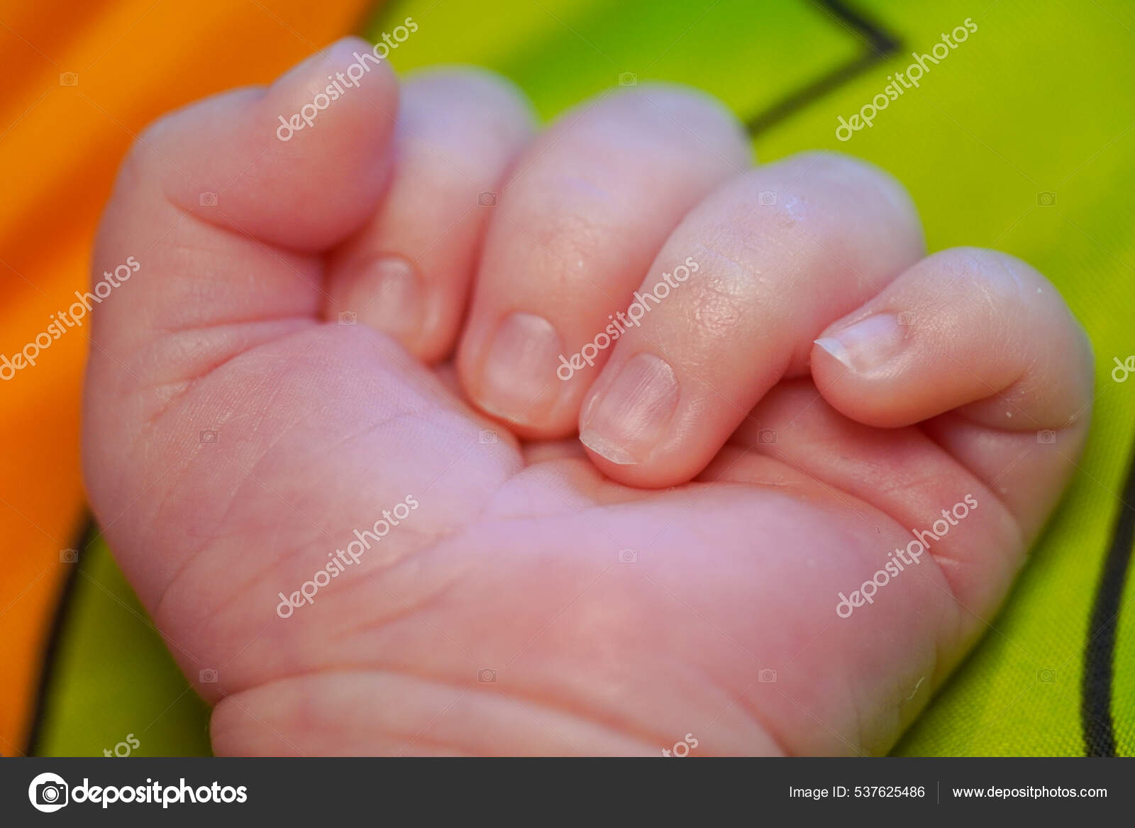 Fingers on hand with the nails of a newborn baby. close up view macro ...