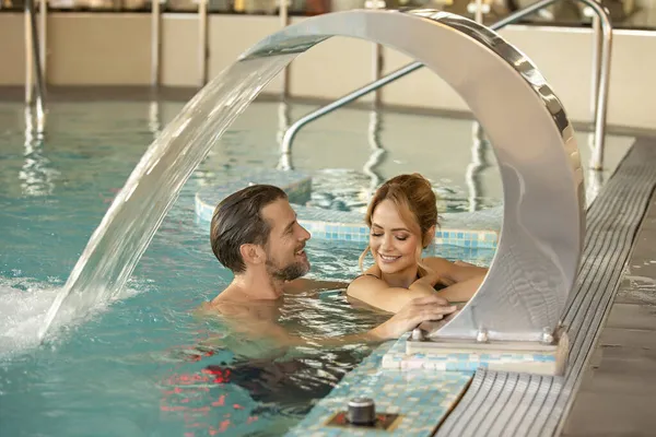 Attractive Young Couple Relaxing Indoor Hotel Swimming Pool — Stock Photo, Image