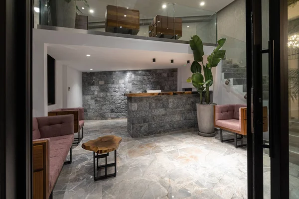 Interior of a hotel reception with stone reception desk in the evening