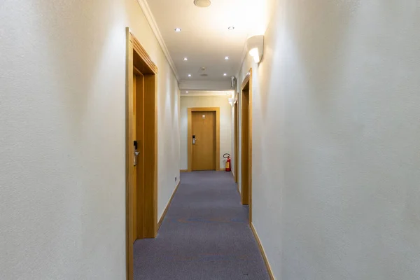 Interior of a hotel corridor with doors with room nummbers