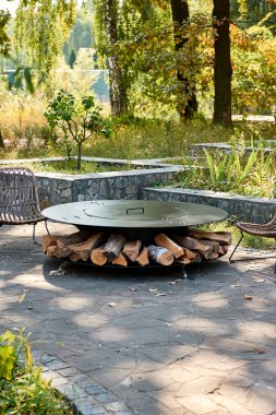 Demir Şebeke 'li Kettle Grill Pit. Yakacak odunlu yuvarlak masa pişirme yüzeyi. Arka bahçede paslanmaz çelik ızgaralı barbekü ızgarası hazır ızgara yemeği. İçinde alevler olan ızgara..