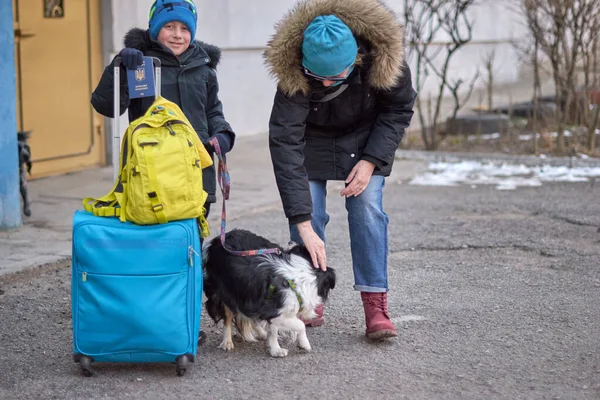 Evacuation of civilians, sad child holding a passport with yellow-blue flag. Stop war