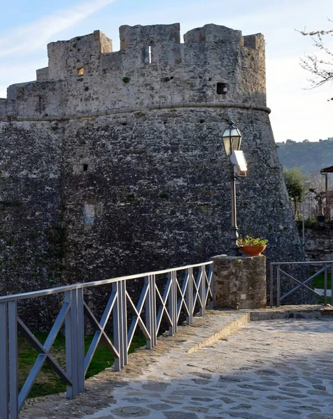 ancient fortress with old stone walls and the rock in background