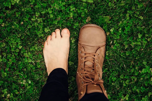 Person wearing barefoot boots shoes, which are wide, comfortable and healthy concept. Wide toe box fits all toes without compressing them together helps keep right body posture.