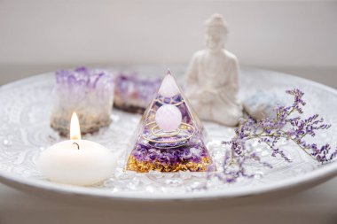 Small altar with Orgonite or Orgone pyramid in home interior. Converting negative energy to positive energy and have healing powers. clipart