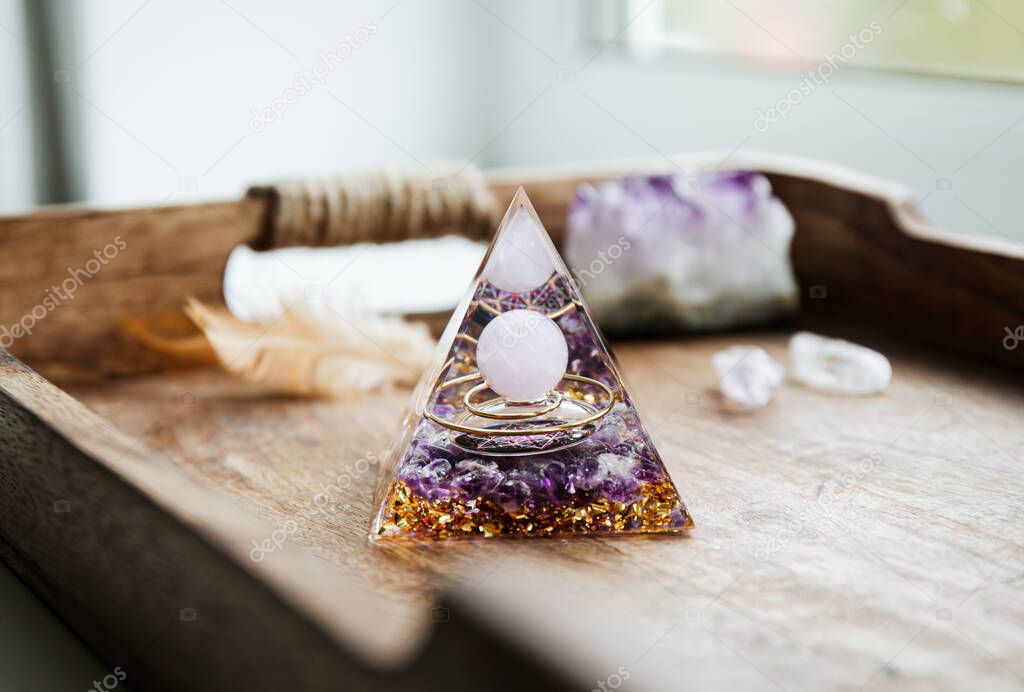 Small home altar with Orgonite or Orgone pyramid indoors. Converting negative energy to positive energy and have healing powers.
