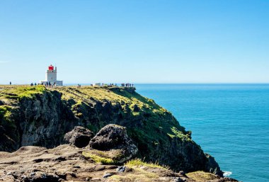Dyrhlaey Lighthouse on island of Iceland on Europe. Popular tourist sight.