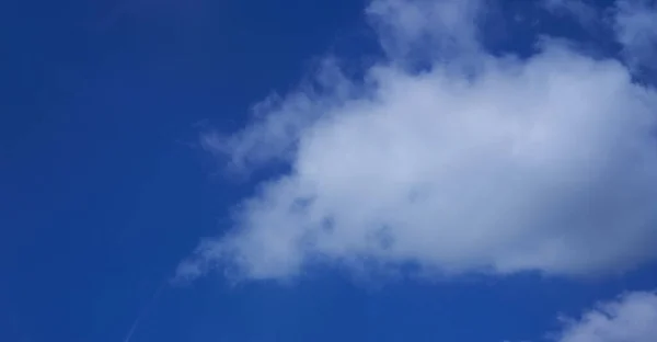 single cloud on blue sky background
