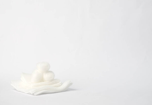 sterile gauze with  cotton balls on top selective focus