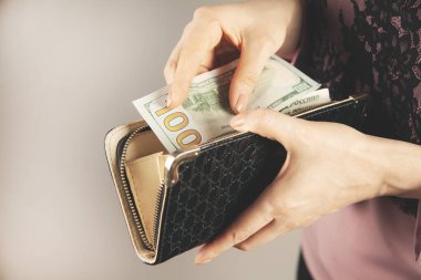 Kadın çantayla para veriyor.