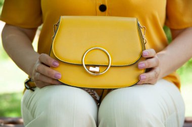 woman hand bag in the park