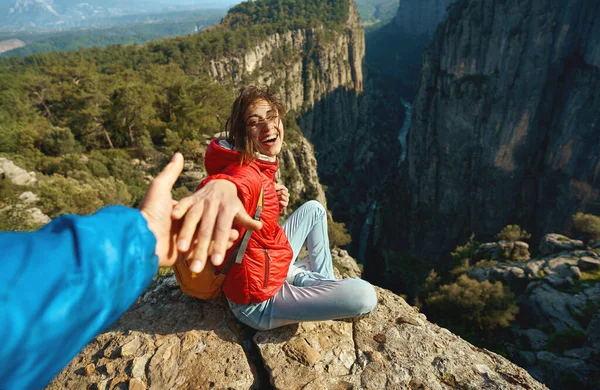 Kvinne som sitter ved klippen og holder noen i hånden. fottur i Tazi-dalen, Tyrkia – stockfoto