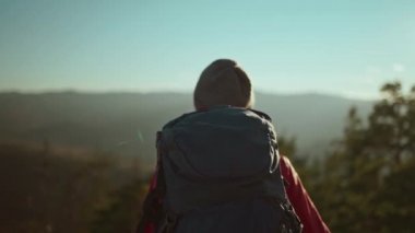 Ağır çekimde. Yüzü olmayan turist kadın. Ellerini kaldırarak uçurumda duruyor, güzel günbatımı gökyüzü ile kanyonun keyfini çıkarıyor.