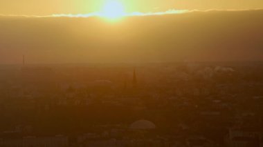 Şehrin üzerinde parlak turuncu gün batımı ve silueti. Lviv, Ukrayna