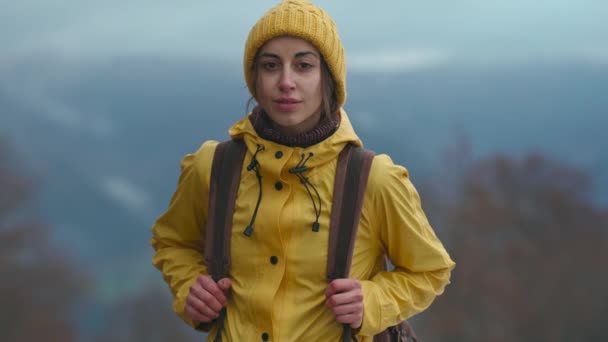 Beautiful woman in yellow wear stands in forest, looks straight, inhale and breathe in fresh after rain air. Travel adventure Scandinavian tourism concept. Roadtrip wanderlust mood — Stockvideo