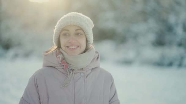 4k slow motion cheerful beautiful woman walking in winter park after snowfall. Trees are standing in the snow at sunny frosty winter day. happy excited girl enjoying frosty freshness — Wideo stockowe