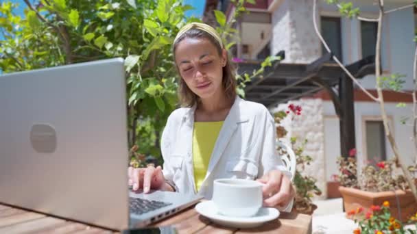 Imagens gimbal dolly close up linda mulher bebendo café usando laptop internet on-line no resort café tropical no dia ensolarado — Vídeo de Stock