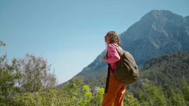 4k rallentatore primo piano ritratto di bella giovane donna escursionista in piedi su un bellissimo paesaggio di montagna, felice ragazza escursioni all'aria aperta nella giornata di sole, avventura stile di vita all'aperto. — Video Stock