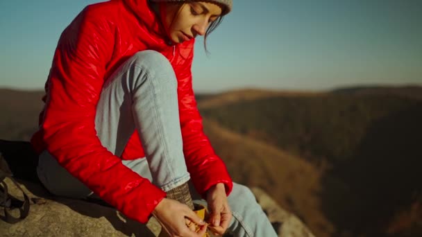 Slow Motion Adventurous Female Hiker Backpacker Red Jacket Backpack Sits — Stockvideo