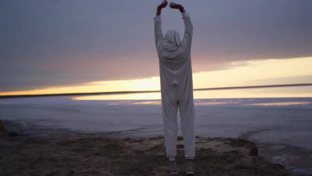 Confident Pretty Woman Funny Pajama Bunny Stands Lake Shore Sunrise — Stock videók