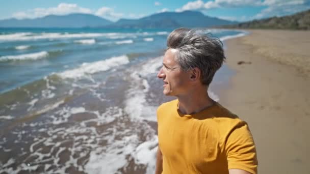 Close Portrait Happy Middle Aged Greyhead Man Walks Sandy Sea — Video