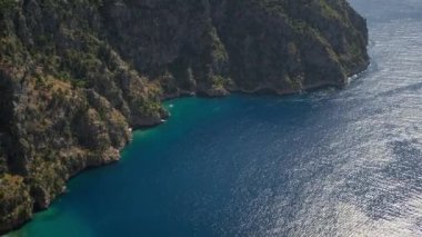 amazing aerial view of Butterfly Valley beach or Kelebekler Vadisi near the city of Oludeniz and Fethiye, Turkey. steep coast and peed turquoise mediterranean sea. go everywhere concept