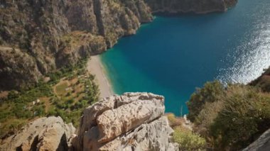 amazing aerial view of Butterfly Valley beach or Kelebekler Vadisi near the city of Oludeniz and Fethiye, Turkey. steep coast and peed turquoise mediterranean sea. go everywhere concept