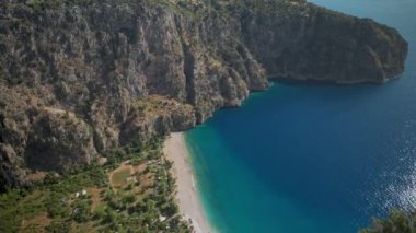 amazing aerial view of Butterfly Valley beach or Kelebekler Vadisi near the city of Oludeniz and Fethiye, Turkey. steep coast and peed turquoise mediterranean sea. go everywhere concept