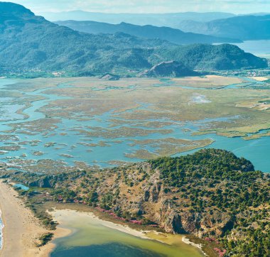 Stunning coastal scenery with Iztuzu Beach, Hill in Dalyan in Turkey. Beautiful nature landscape sea bay view with mountains range