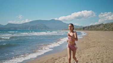 Runner WoMan Fit Athlete Jogging On Beach Sport Triathlon. Triathlete Running, Sprinting And Endurance Marathon Workout. Running WoMan Healthy Lifestyle. Runner Jog sea beach. Sport Recreation Fitness