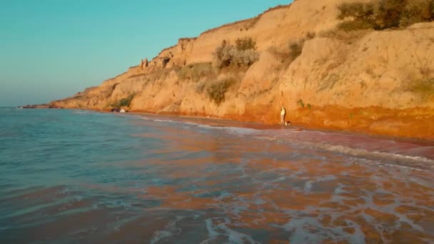 Donna Corre Lunga Spiaggia Sabbia Con Colline Argilla Lungo Mare — Video Stock