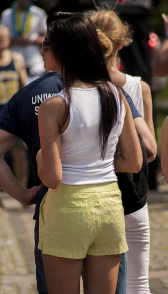 Sexy college girl in pants shorts. — Stock Photo, Image