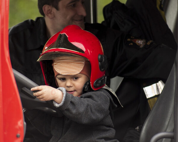 Child in a fireman's helmet in the Fire Truck
