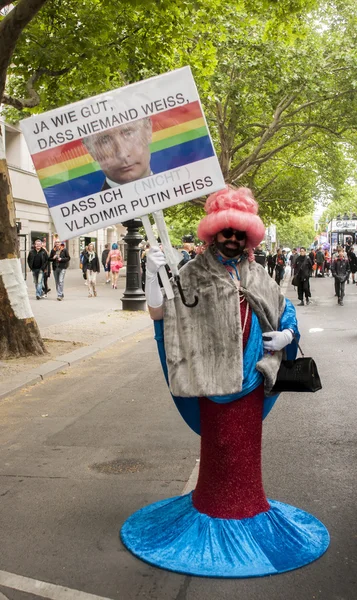Elaborately dressed man with placard — Stock Photo, Image