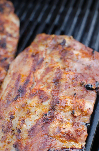 Spareribs on grill with dip and toasted baguette — Stock Photo, Image